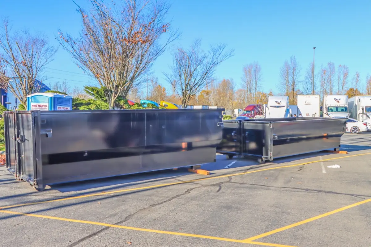 Professional dumpster rental service with roll-off container on residential driveway in Loveland